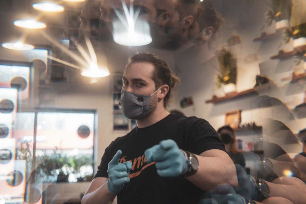 Remedy Working pointing at camera inside Remedy Dispensary